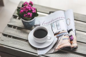 photo of coffee, magazine and flowers